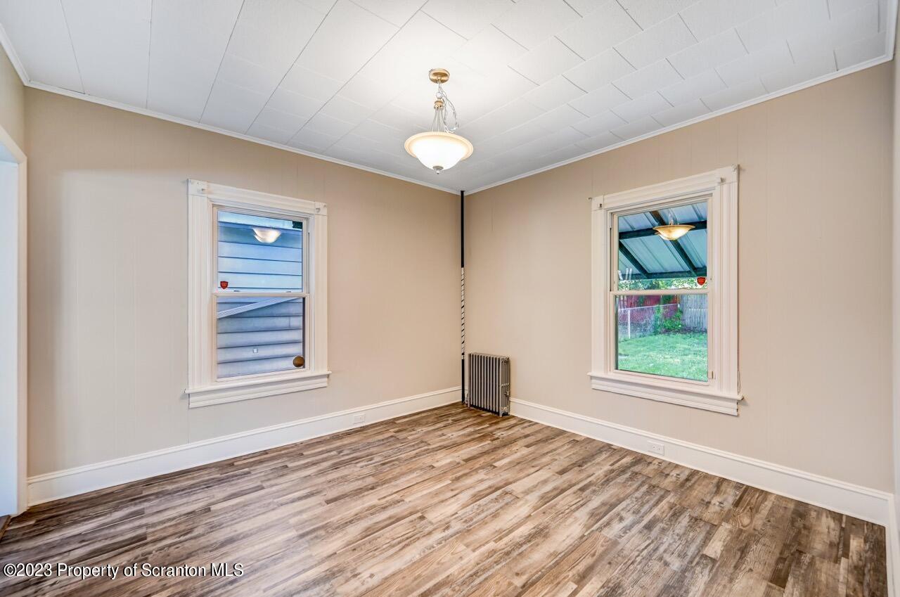915 Ridge Avenue Scranton, PA 18510 - Photo 7 of 39 a view of an empty room with wooden floor and a window