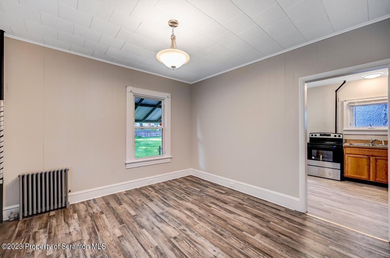 915 Ridge Avenue Scranton, PA 18510 - Photo 8 of 39 a view of a room with wooden floor and kitchen