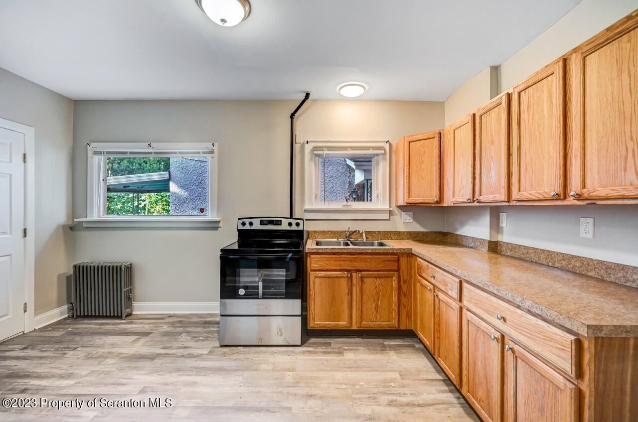 915 Ridge Avenue Scranton, PA 18510 - Photo 9 of 39 a kitchen with stainless steel appliances granite countertop a stove a sink and a microwave