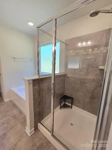 a bathroom with a bathtub and a window