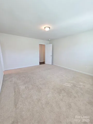 a bathroom with a granite countertop sink a toilet and a mirror