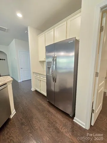 a kitchen with a refrigerator and a sink