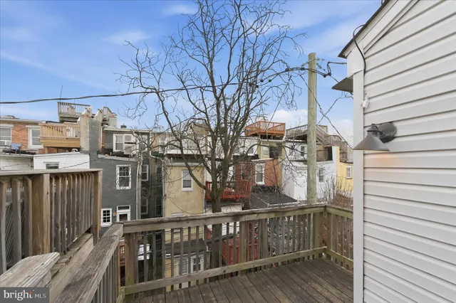 a view of a house with a wooden fence