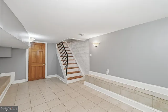 a view of room with stairs and white walls