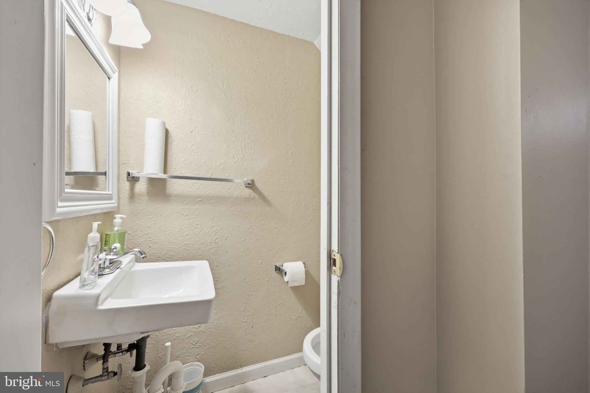 5203 Bay Road, Unit N Bensalem, PA 19020 - Photo 23 of 27 a bathroom with a sink a toilet and mirror
