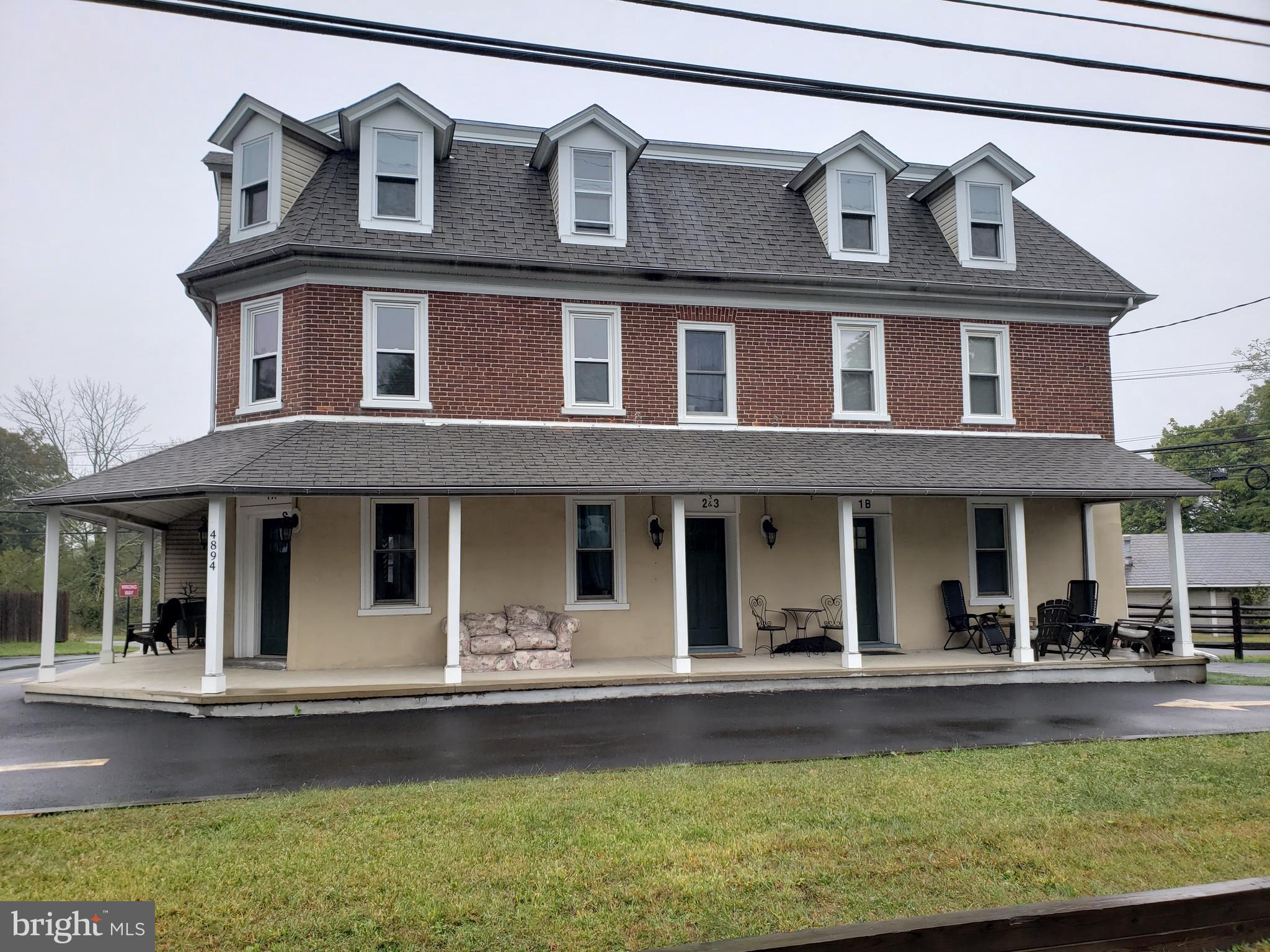 a view of house with a yard and swimming pool
