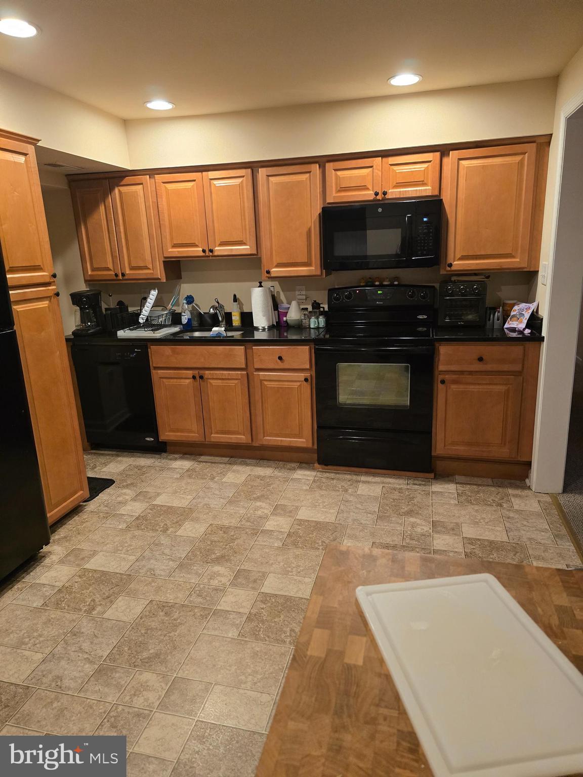 4894 Old Easton Road Doylestown, PA 18902 - Photo 10 of 19 a kitchen with stainless steel appliances kitchen island granite countertop a stove a sink and a microwave