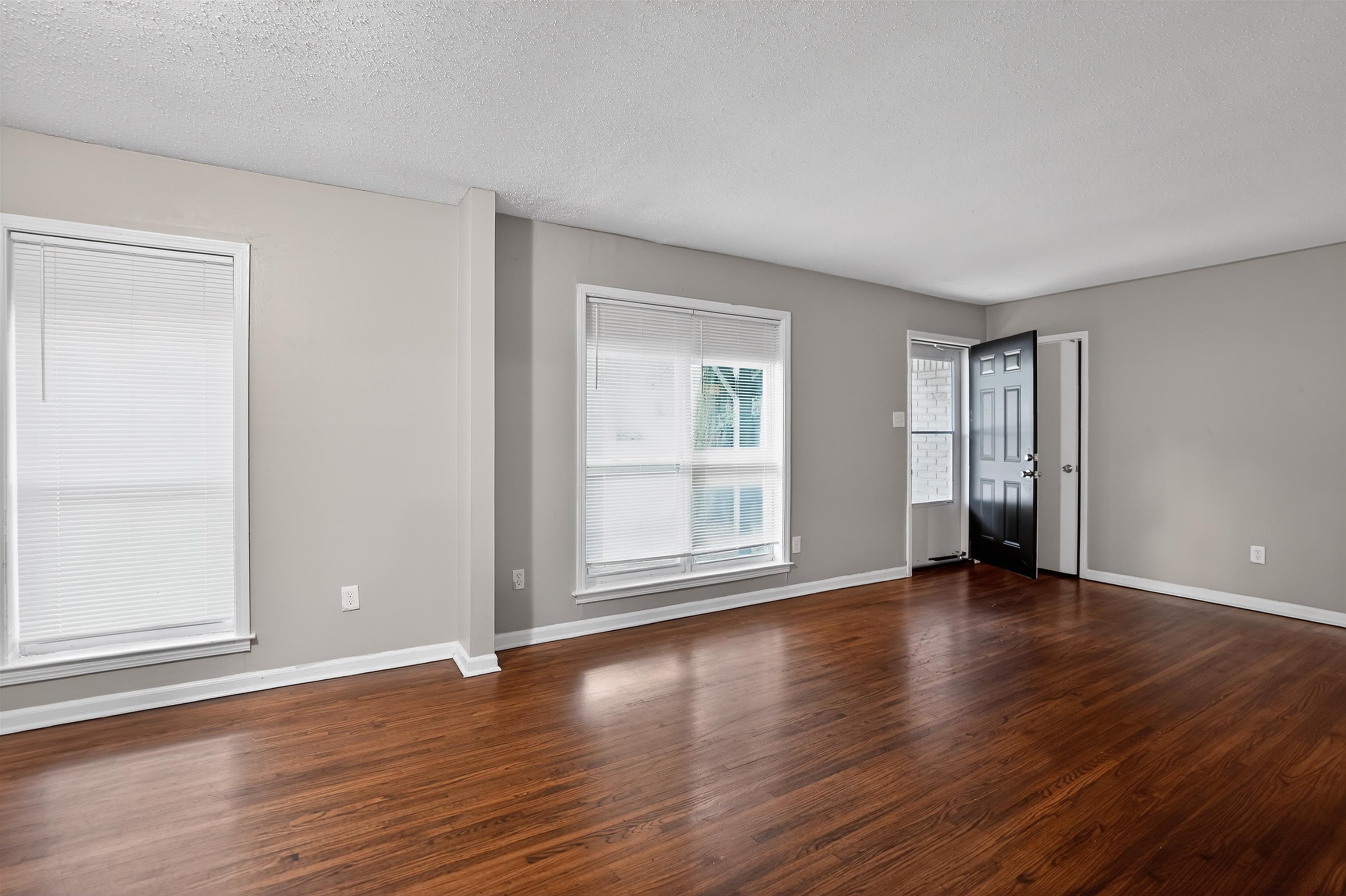 4191 Yale Road Memphis, TN 38128 - Photo 11 of 22 Spacious room featuring wood-finish flooring, light gray wall paint, and white trim