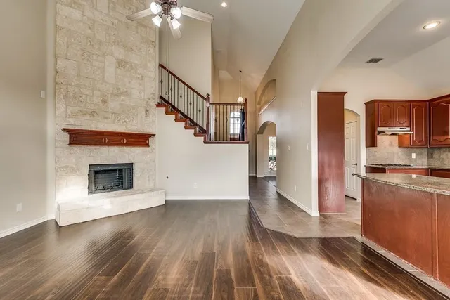 a view of a kitchen with a sink a kitchen stove top oven and refrigerator