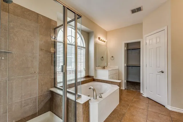 a spacious bathroom with a tub and shower