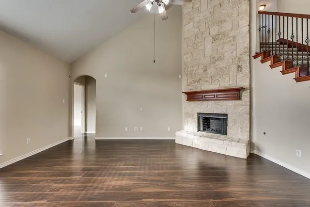 a view of a livingroom with wooden floor a fireplace and window