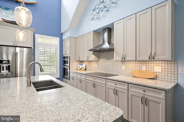 a bathroom with a granite countertop shower