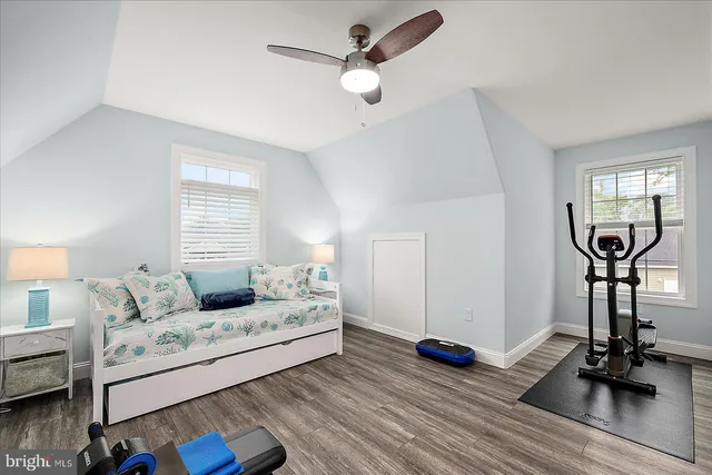 a view of a house with a yard and potted plants