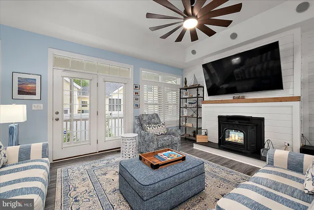 a kitchen with stainless steel appliances a dining table chairs and refrigerator