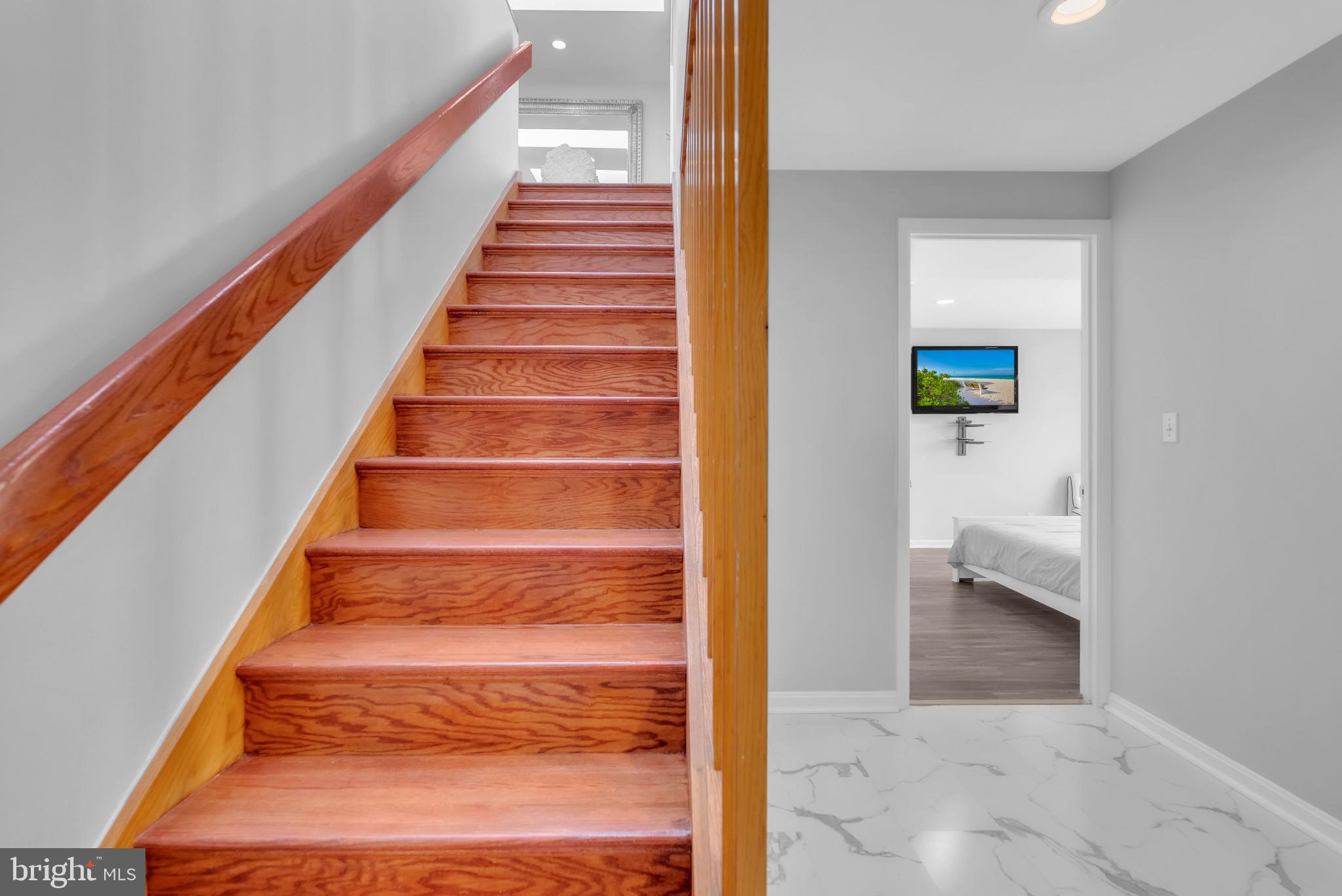 14933 Wellwood Road Silver Spring, MD 20905 - Photo 27 of 50 Inviting staircase leads to serene spaces.
