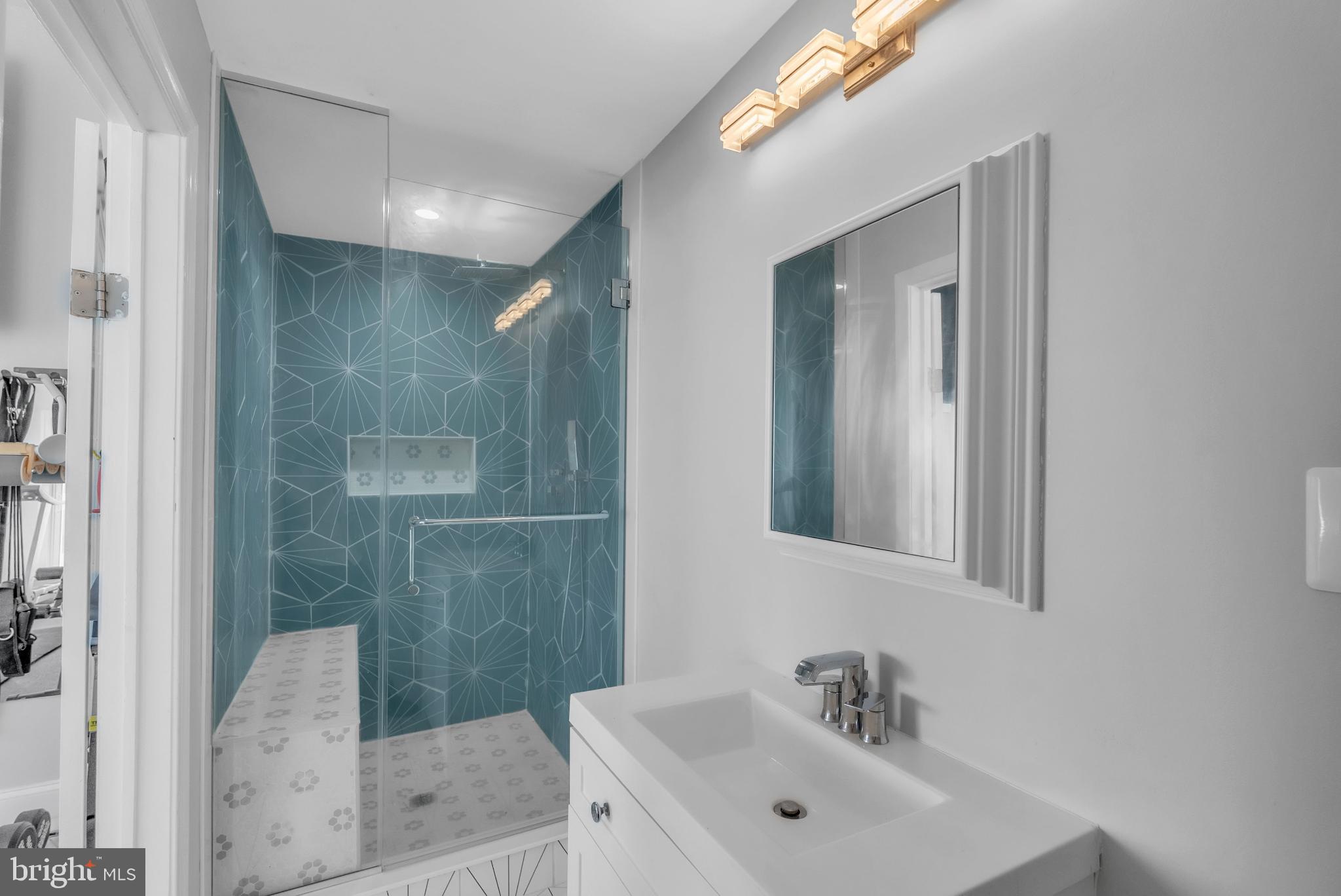 14933 Wellwood Road Silver Spring, MD 20905 - Photo 45 of 50 Sleek modern bathroom with vibrant accents.