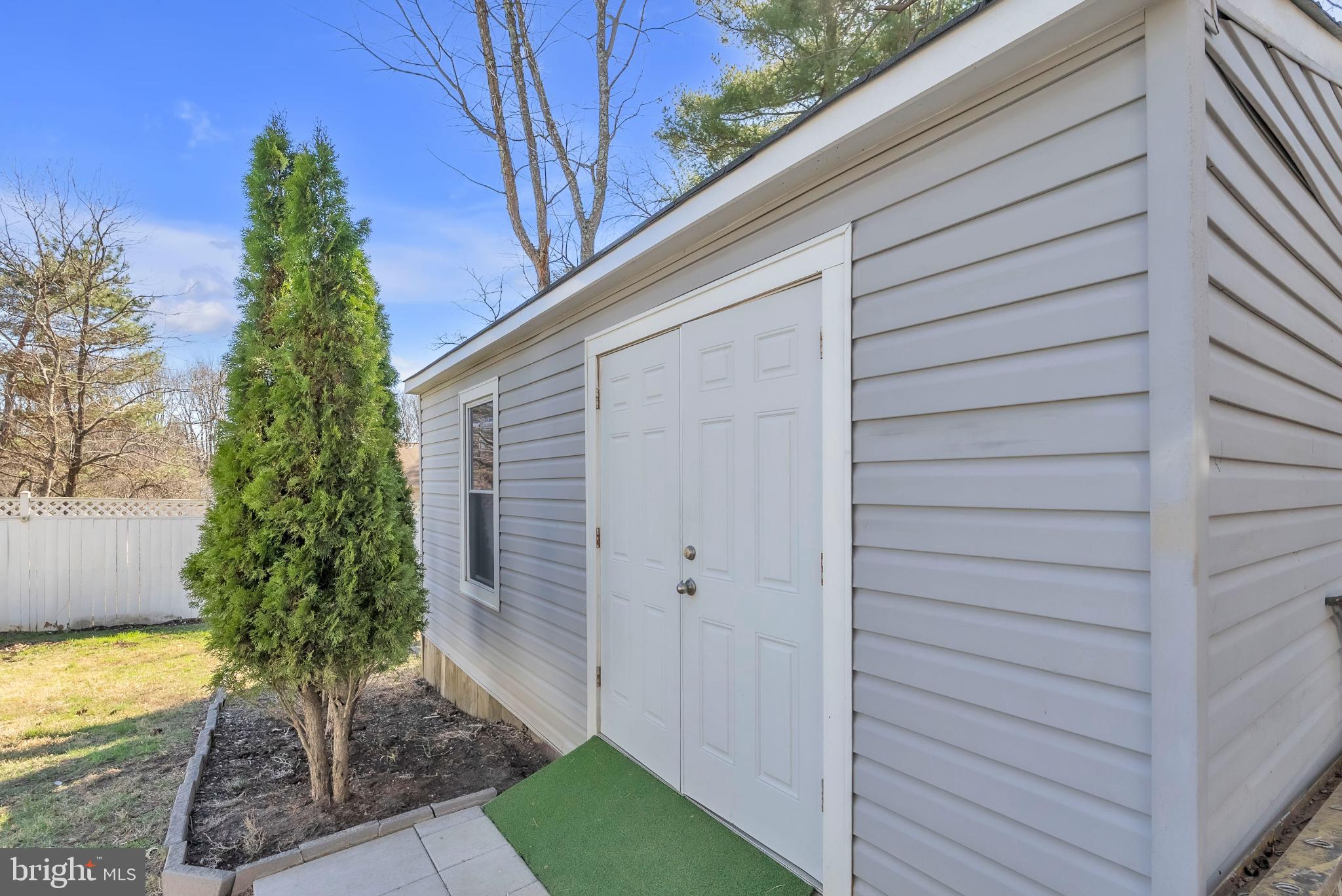 14933 Wellwood Road Silver Spring, MD 20905 - Photo 47 of 50 Convenient shed with lush greenery.