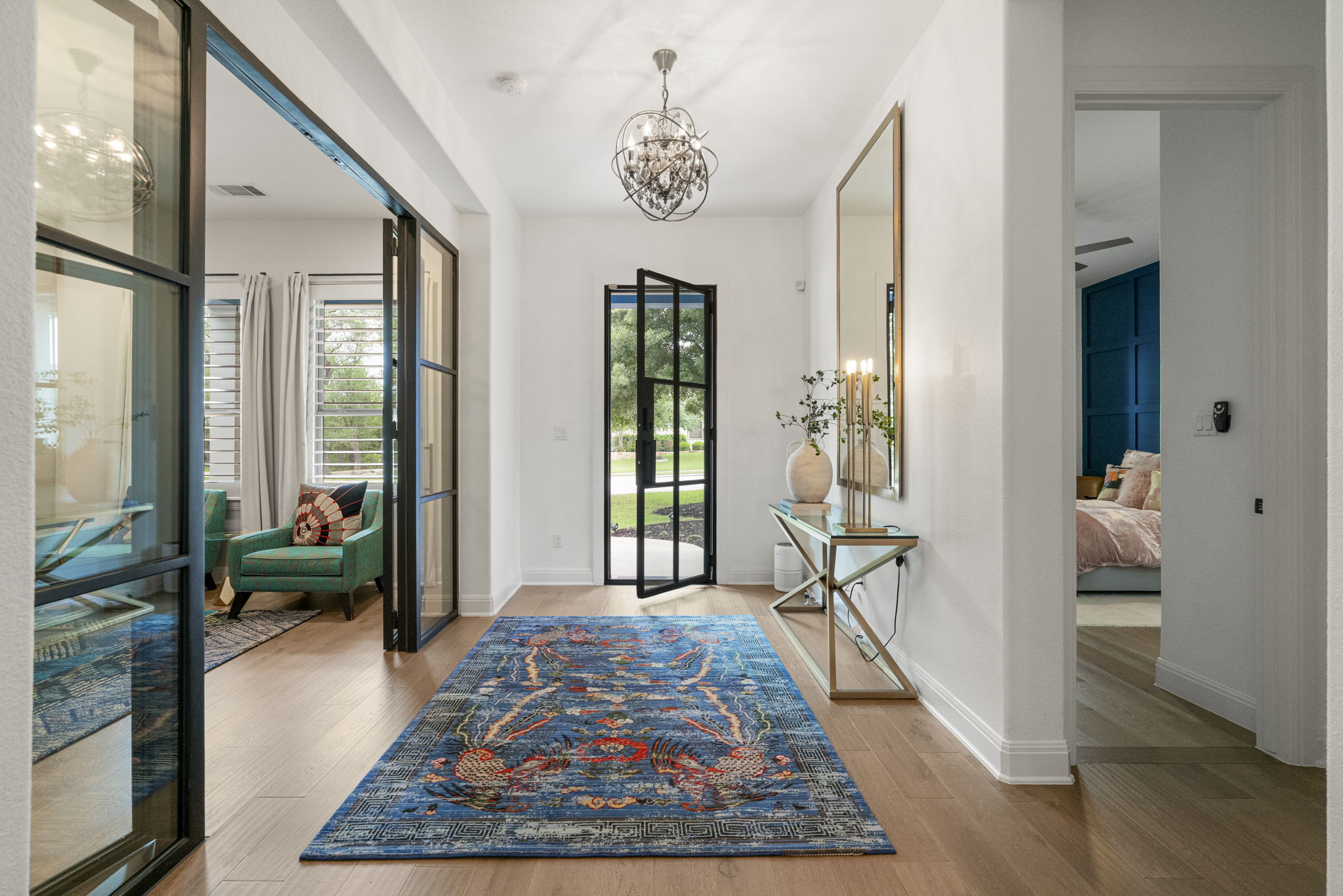 288 Hazy Hills Loop Dripping Springs, TX 78620 - Photo 9 of 40 A welcoming entry features a steel-and-glass door, soaring ceilings, and an immediate sense of openness and flow.