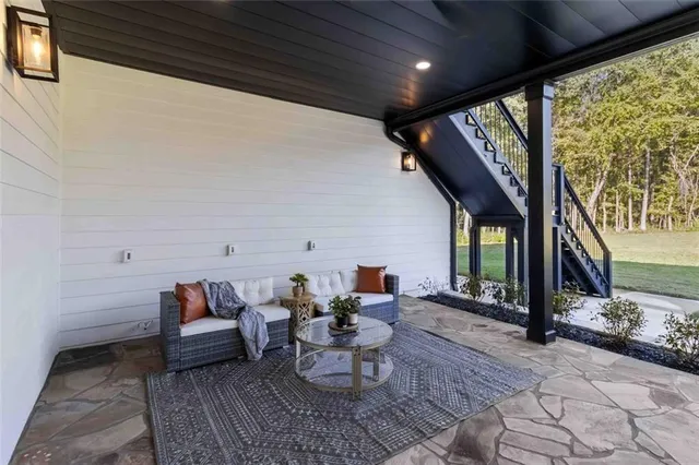 a living room with furniture and a floor to ceiling window