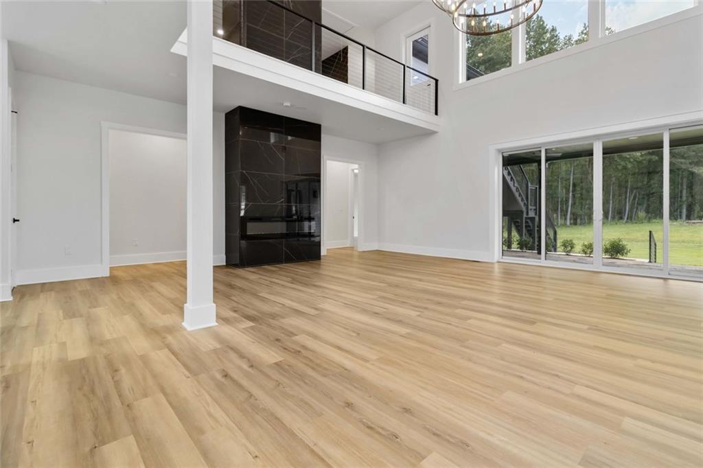 1604 Greendale Road Covington, GA 30014 - Photo 14 of 68 an empty room with wooden floor and windows