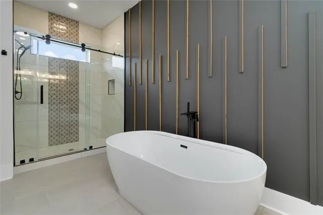 a bathroom with a bathtub and shower