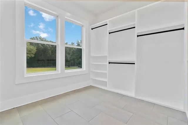 a view of an empty room with a window and a shower