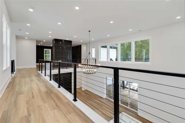 a view of a kitchen with kitchen island granite countertop wooden floor stainless steel appliances and a window