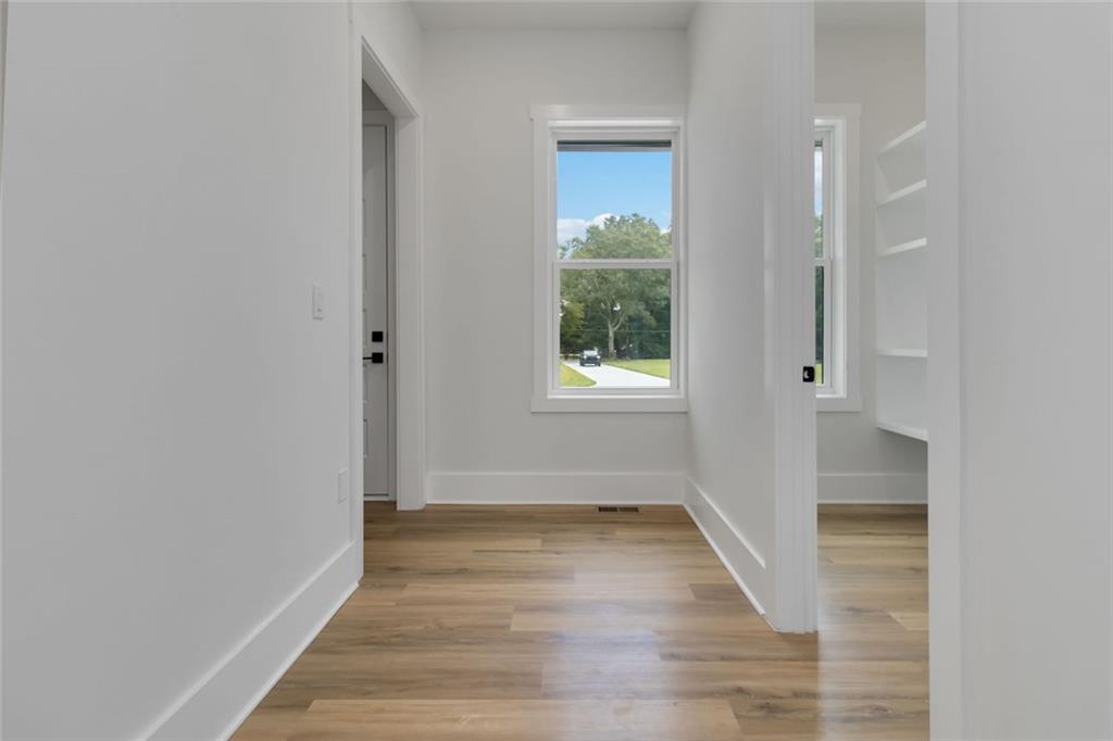 1604 Greendale Road Covington, GA 30014 - Photo 25 of 68 an empty room with wooden floor and windows