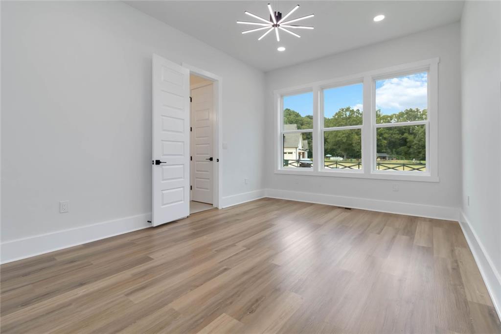 1604 Greendale Road Covington, GA 30014 - Photo 27 of 68 a view of an empty room with wooden floor and a window