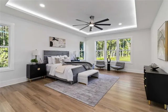 a spacious bedroom with a bed couch and a window