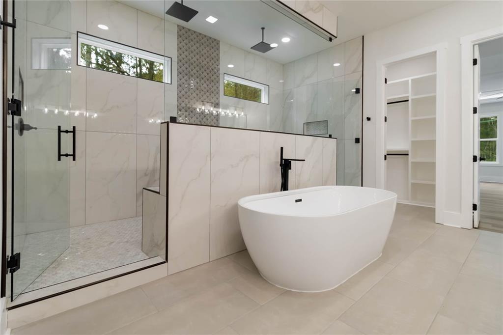 1604 Greendale Road Covington, GA 30014 - Photo 39 of 68 a bathroom with a bathtub and shower