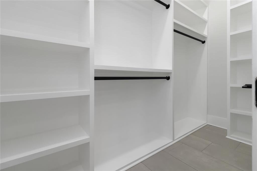 1604 Greendale Road Covington, GA 30014 - Photo 40 of 68 a view of walk in closet with empty racks