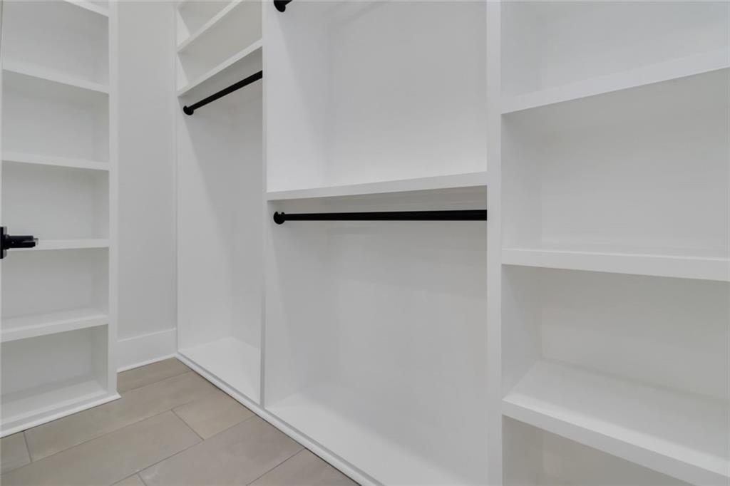 1604 Greendale Road Covington, GA 30014 - Photo 41 of 68 a view of walk in closet with empty racks