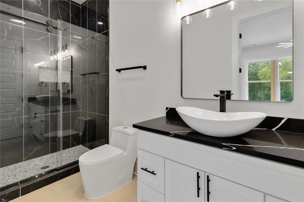 1604 Greendale Road Covington, GA 30014 - Photo 45 of 68 a bath room with a sink and a mirror