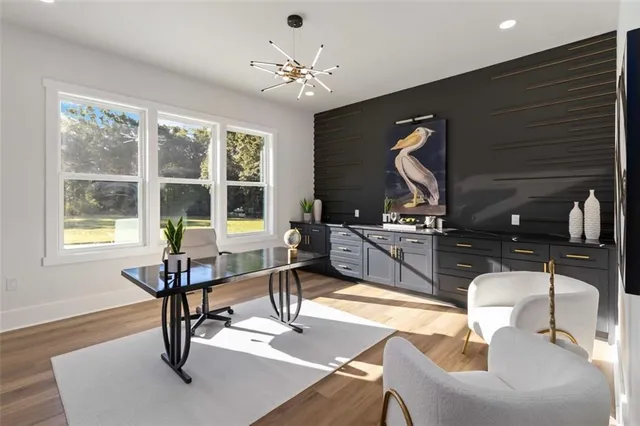a living room with furniture a dining table and a large window