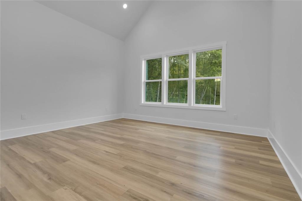 1604 Greendale Road Covington, GA 30014 - Photo 51 of 68 an empty room with wooden floor and windows
