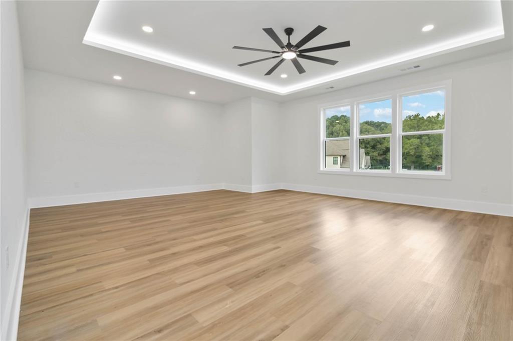 1604 Greendale Road Covington, GA 30014 - Photo 56 of 68 an empty room with wooden floor and windows
