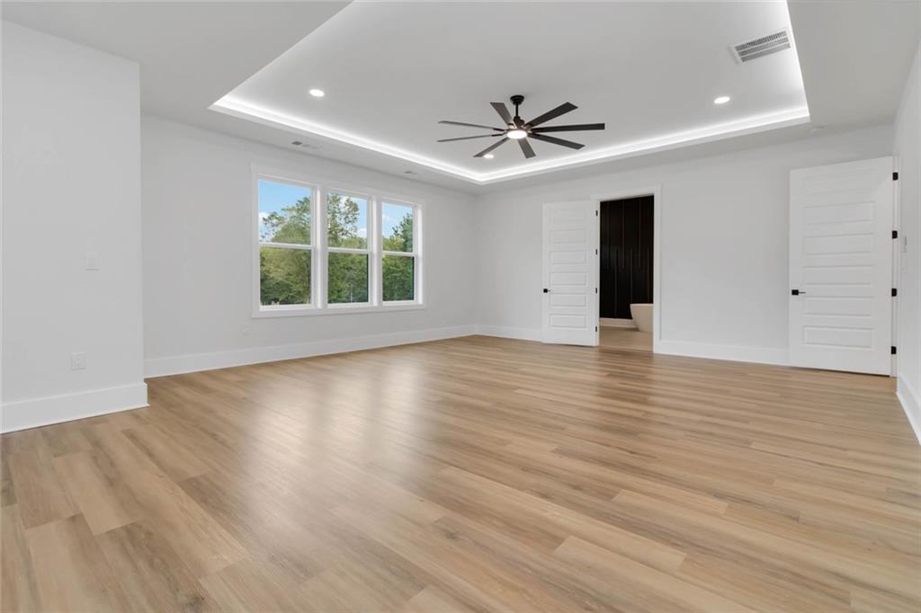 1604 Greendale Road Covington, GA 30014 - Photo 57 of 68 a view of an empty room with wooden floor and a window