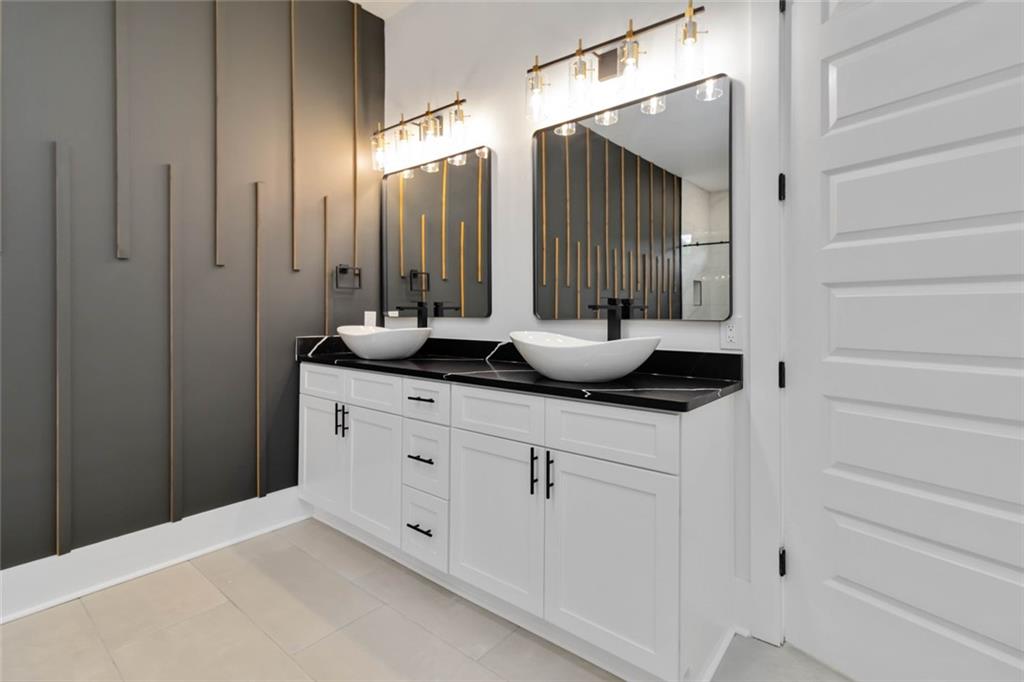 1604 Greendale Road Covington, GA 30014 - Photo 59 of 68 a bathroom with a granite countertop sink and a mirror