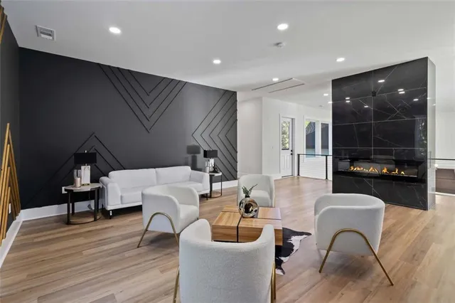 a living room with furniture and a wooden floor