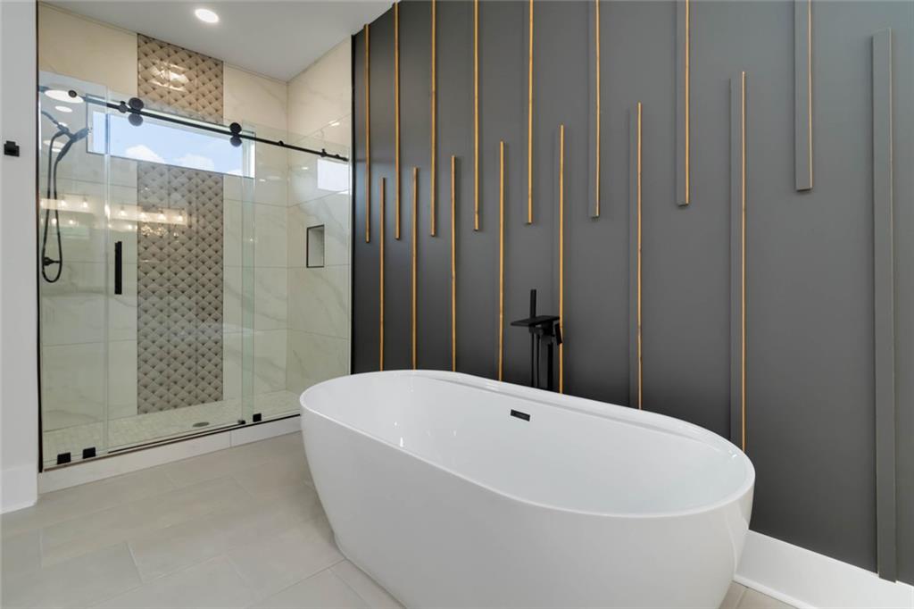 1604 Greendale Road Covington, GA 30014 - Photo 61 of 68 a bathroom with a bathtub and shower