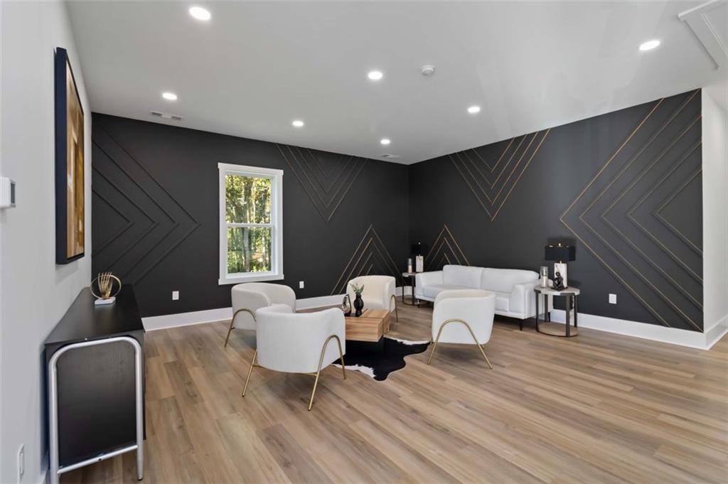 1604 Greendale Road Covington, GA 30014 - Photo 9 of 23 a living room with couches and painted walls with wooden floor