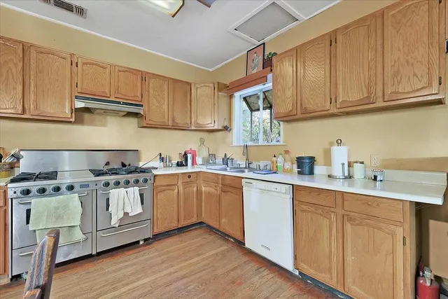 wooden floor fireplace and windows in an empty room