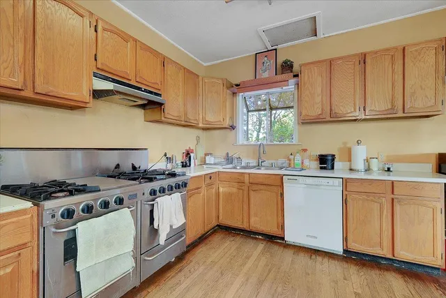 a bedroom with a bed mirror and a large window