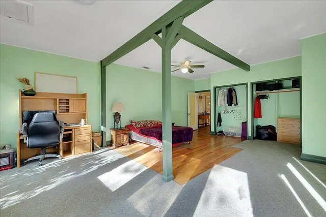 a white toilet sitting next to a white wall