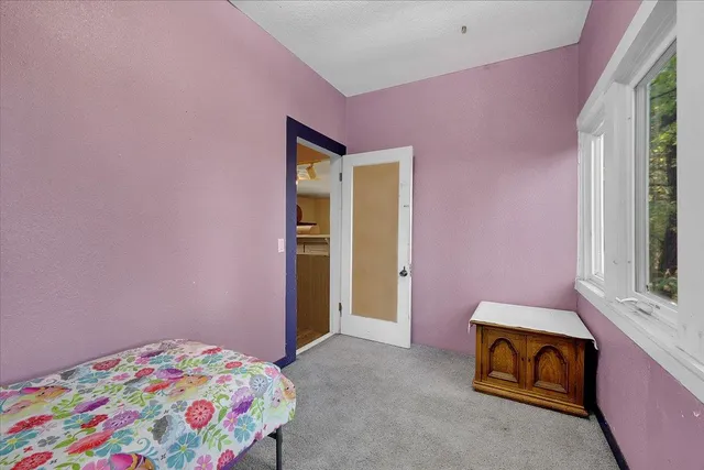 a view of a livingroom with a ceiling fan and window