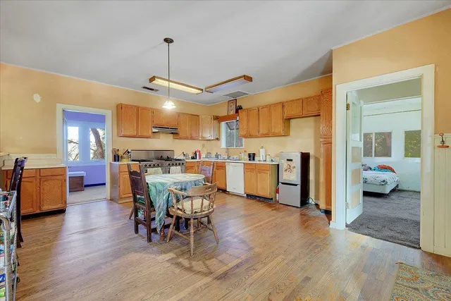 a kitchen with a table chairs stove and cabinets