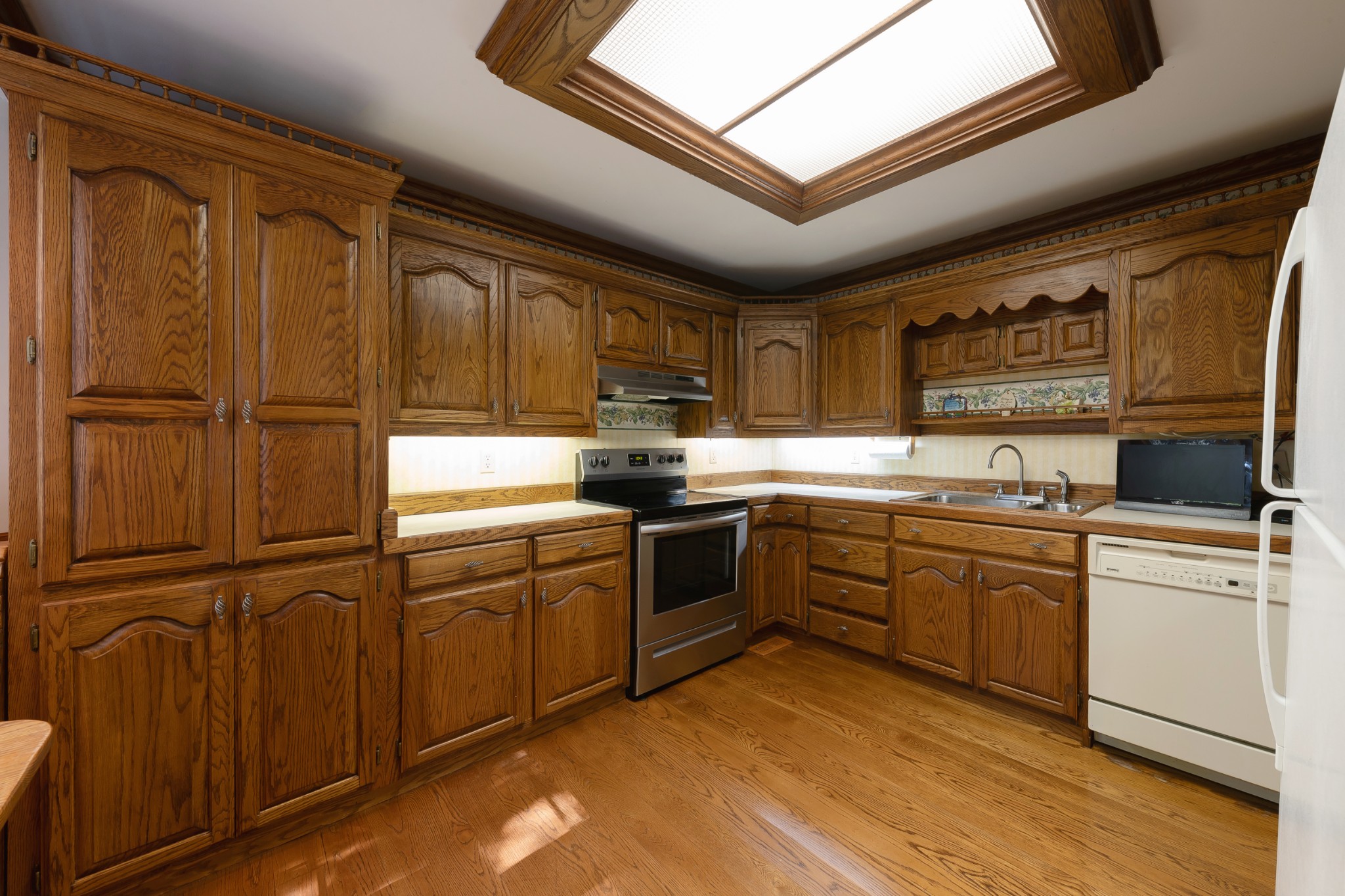 634 Murrell Road Dickson, TN 37055 - Photo 25 of 46 a kitchen with granite countertop stainless steel appliances and wooden cabinets