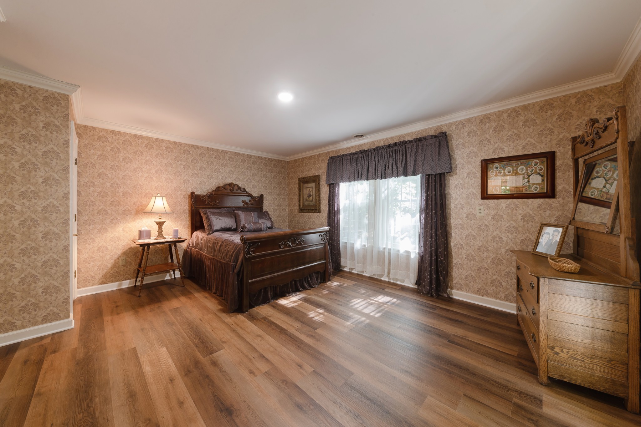 634 Murrell Road Dickson, TN 37055 - Photo 37 of 46 a bedroom with a bed and wooden floor