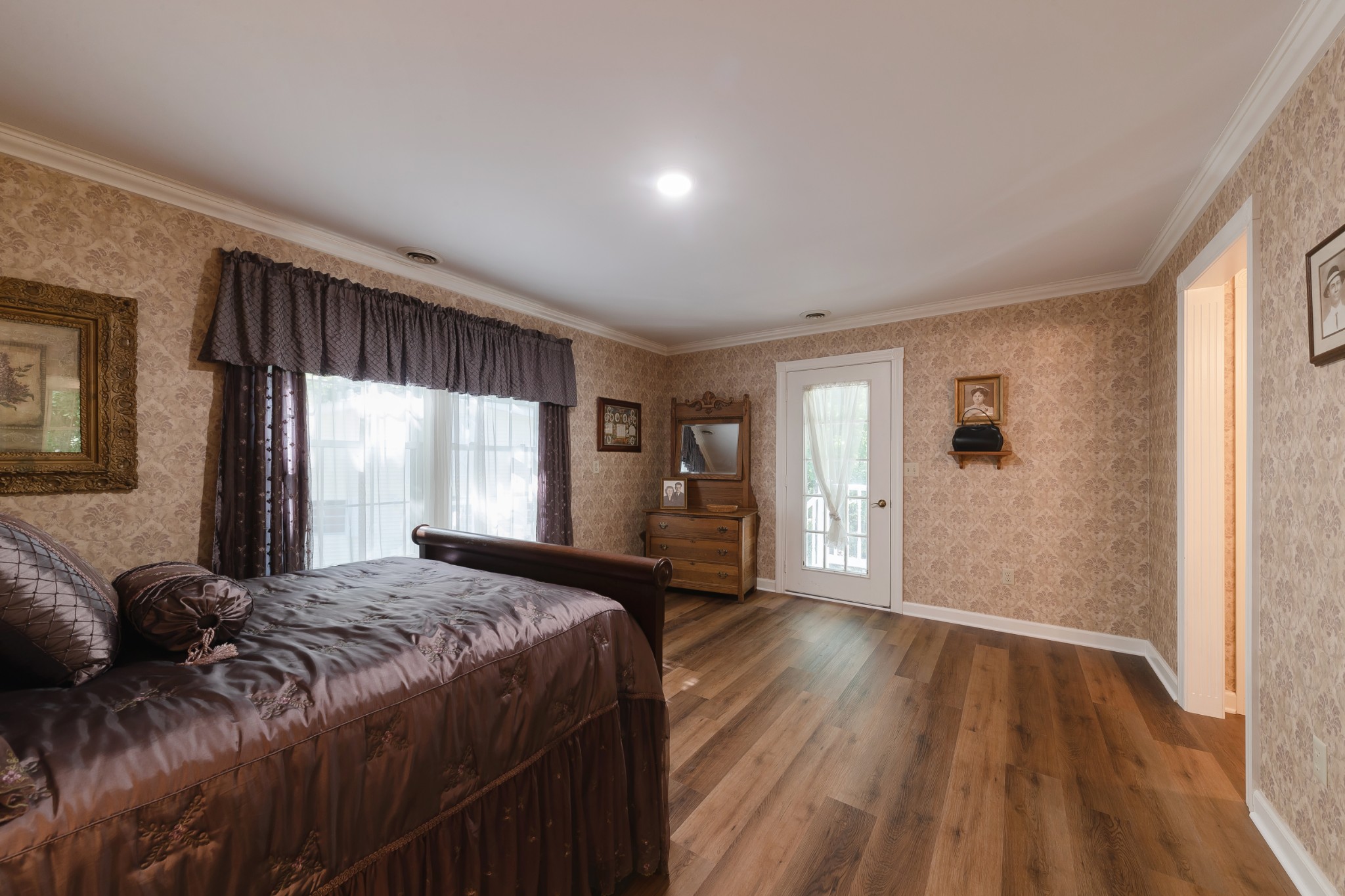 634 Murrell Road Dickson, TN 37055 - Photo 38 of 46 a spacious bedroom with a bed and wooden floor